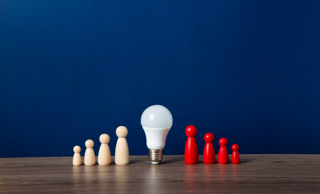 A light bulb and a wooden doll on the desk